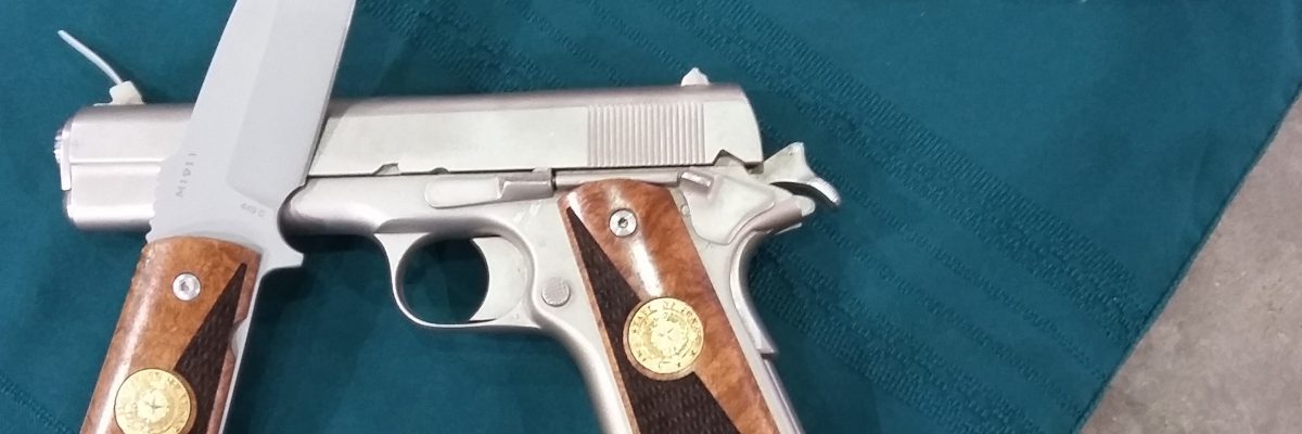 Photo of stainless steel 1911 and knife with matching two-tone wood grips.